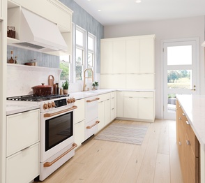 Modern kitchen with a white backsplash, stainless steel faucet, and a clean, minimalist design. Image the Nouveau Collection.