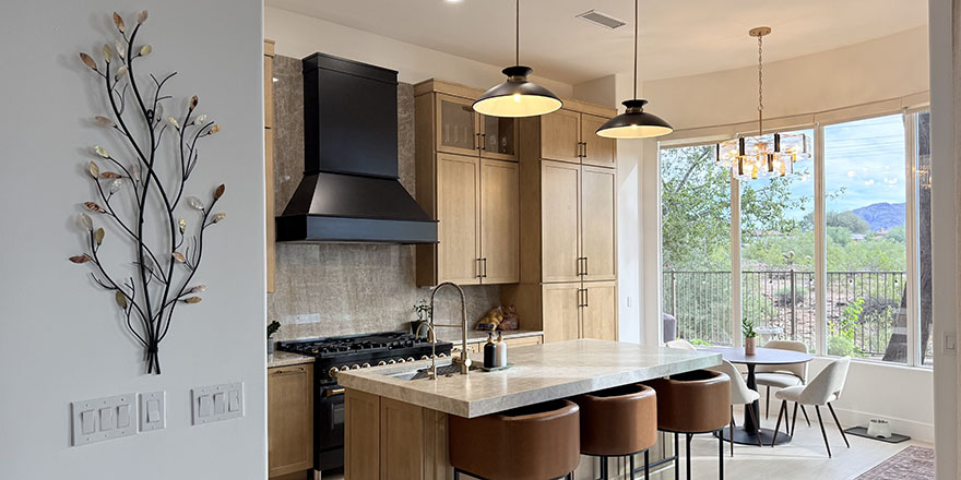 Modern kitchen with navy blue cabinetry, stainless steel appliances, and a sink.