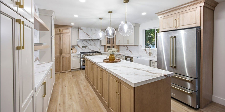 Bright kitchen with white cabinetry, a stainless steel refrigerator, and a coffee station beside the microwave.
